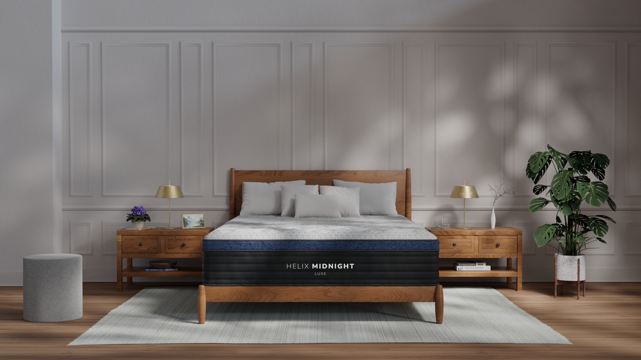The Helix Midnight Luxe on display in a sun dappled room with nightstands and a plant