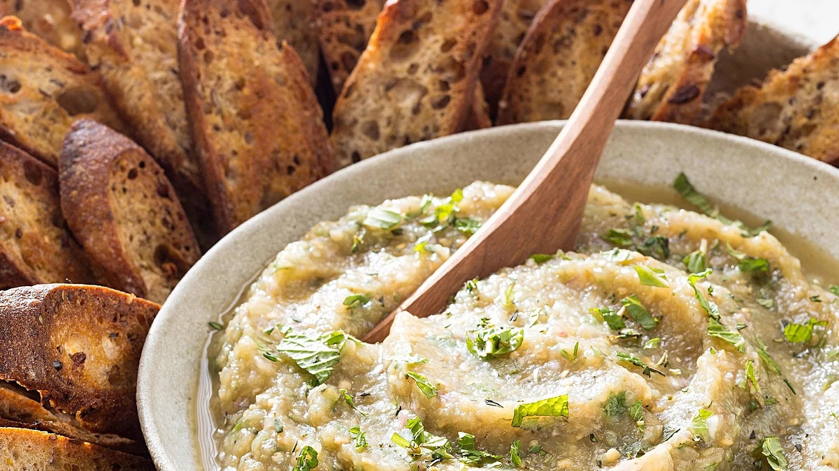 A close-up view of grilled eggplant dip in a bowl