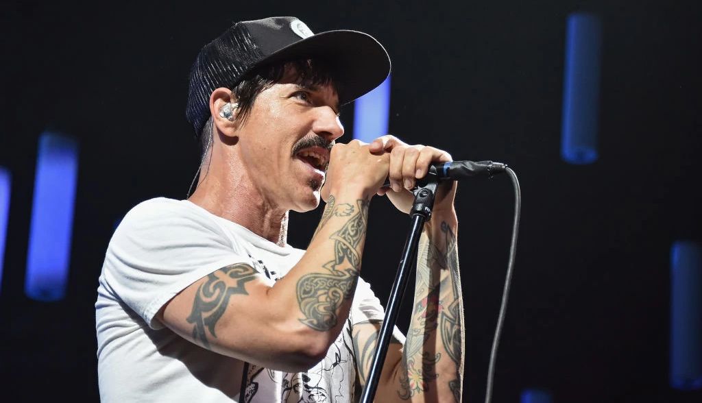 Anthony Kiedis of the Red Hot Chili Peppers signing into a microphone