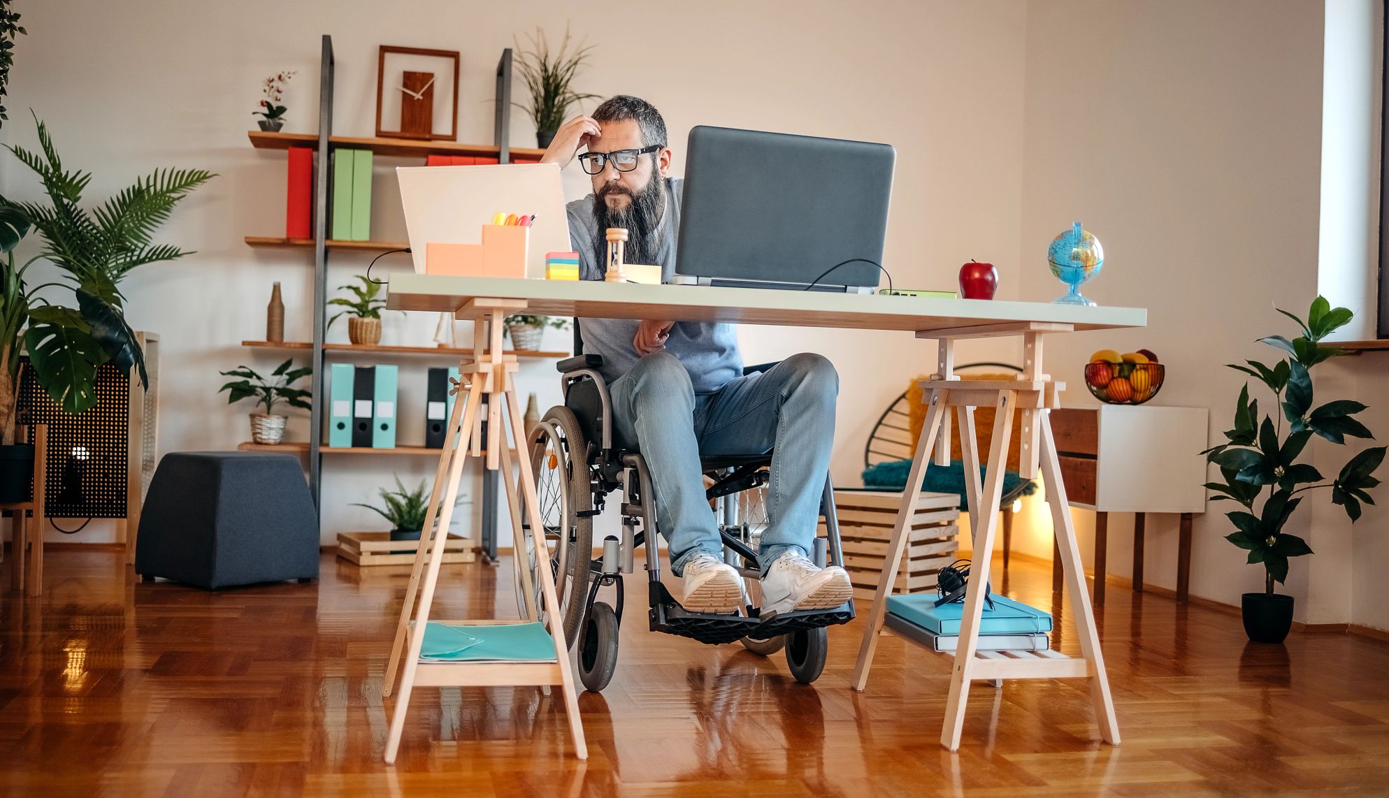 Remote Work Can Help People with Disabilities Get Hired man in wheelchair working from home