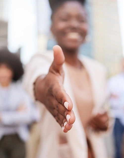A woman reaching out for a handshake.