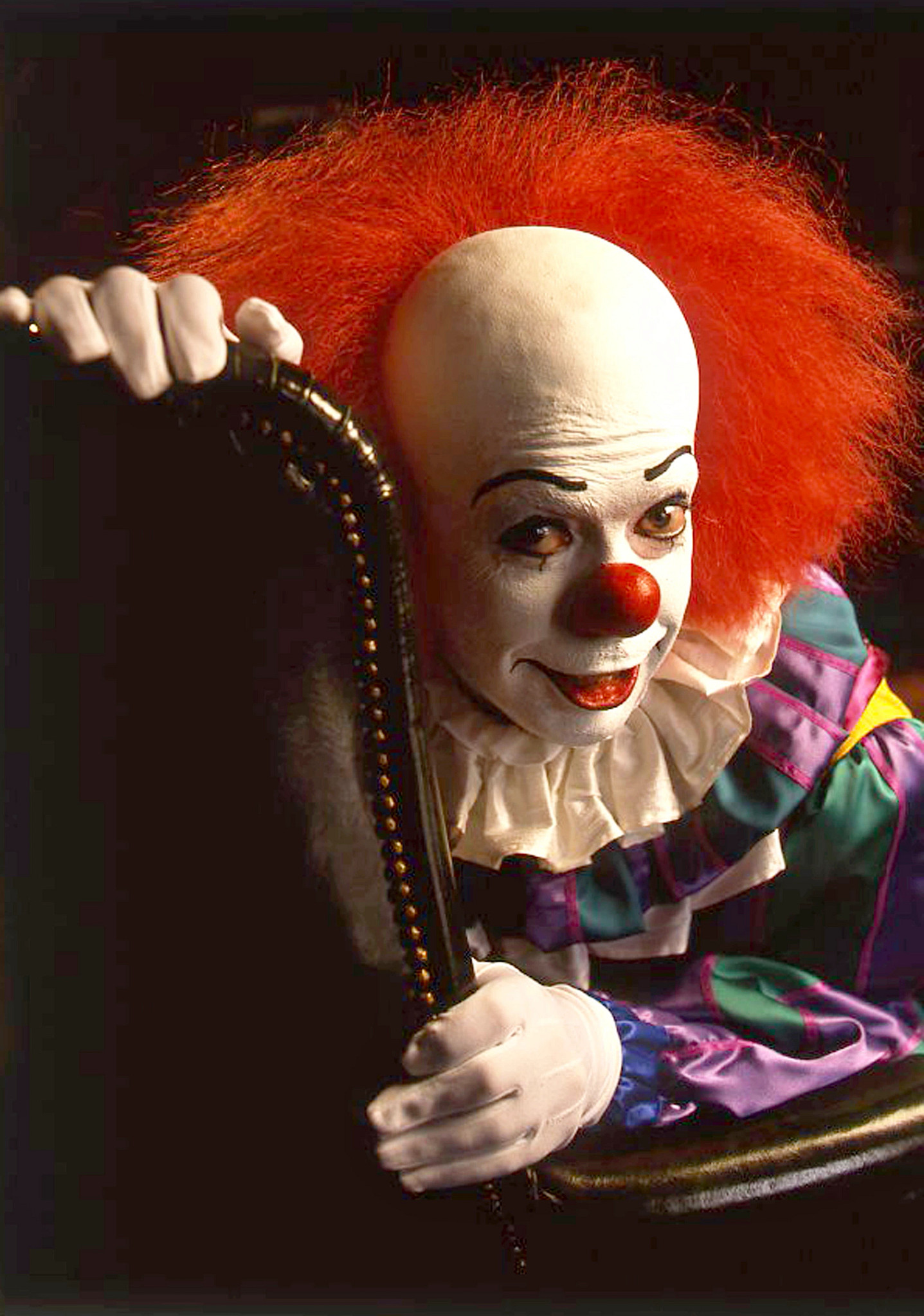 tim curry in a clown getup for his role as pennywise in it