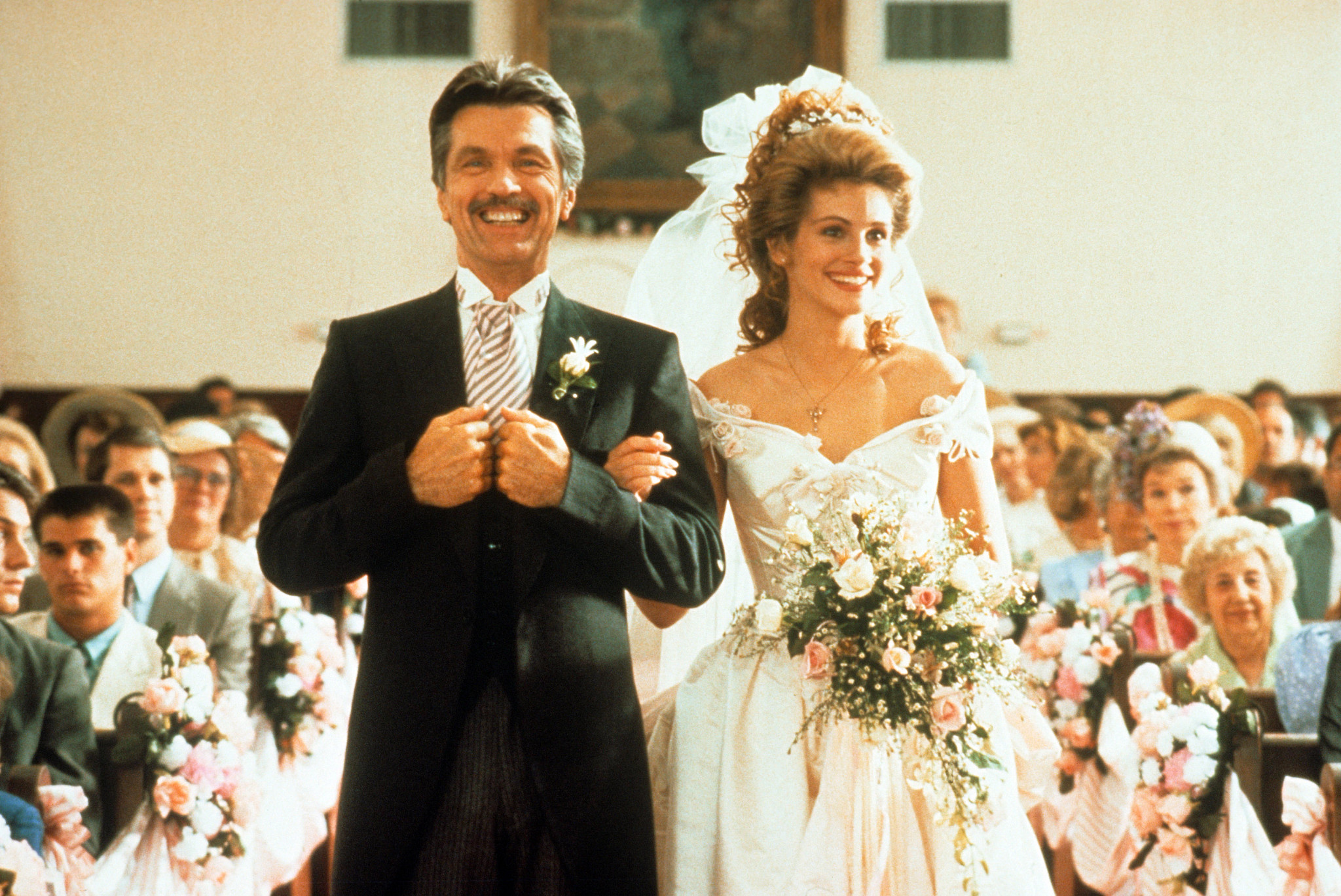 tom skerritt and julia roberts walk down the aisle together at a wedding