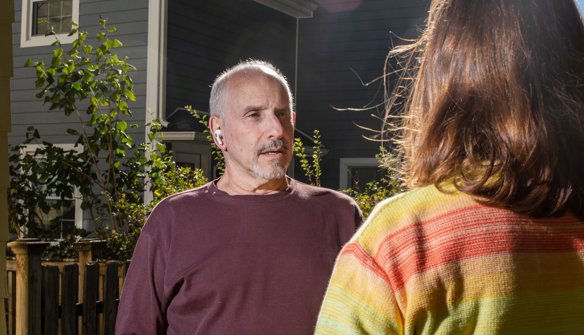 testing airpods as hearing aids man wearing ear buds talking to a woman