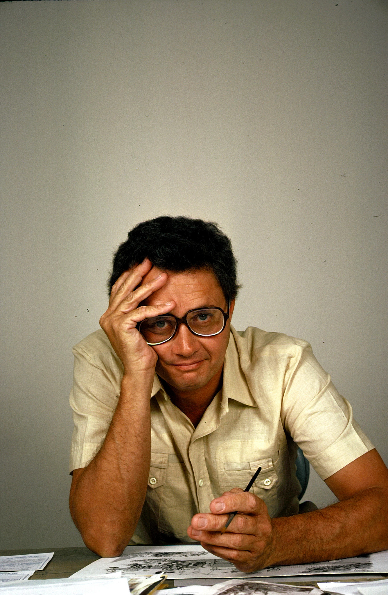 head shot of pat oliphant in glasses holding his head