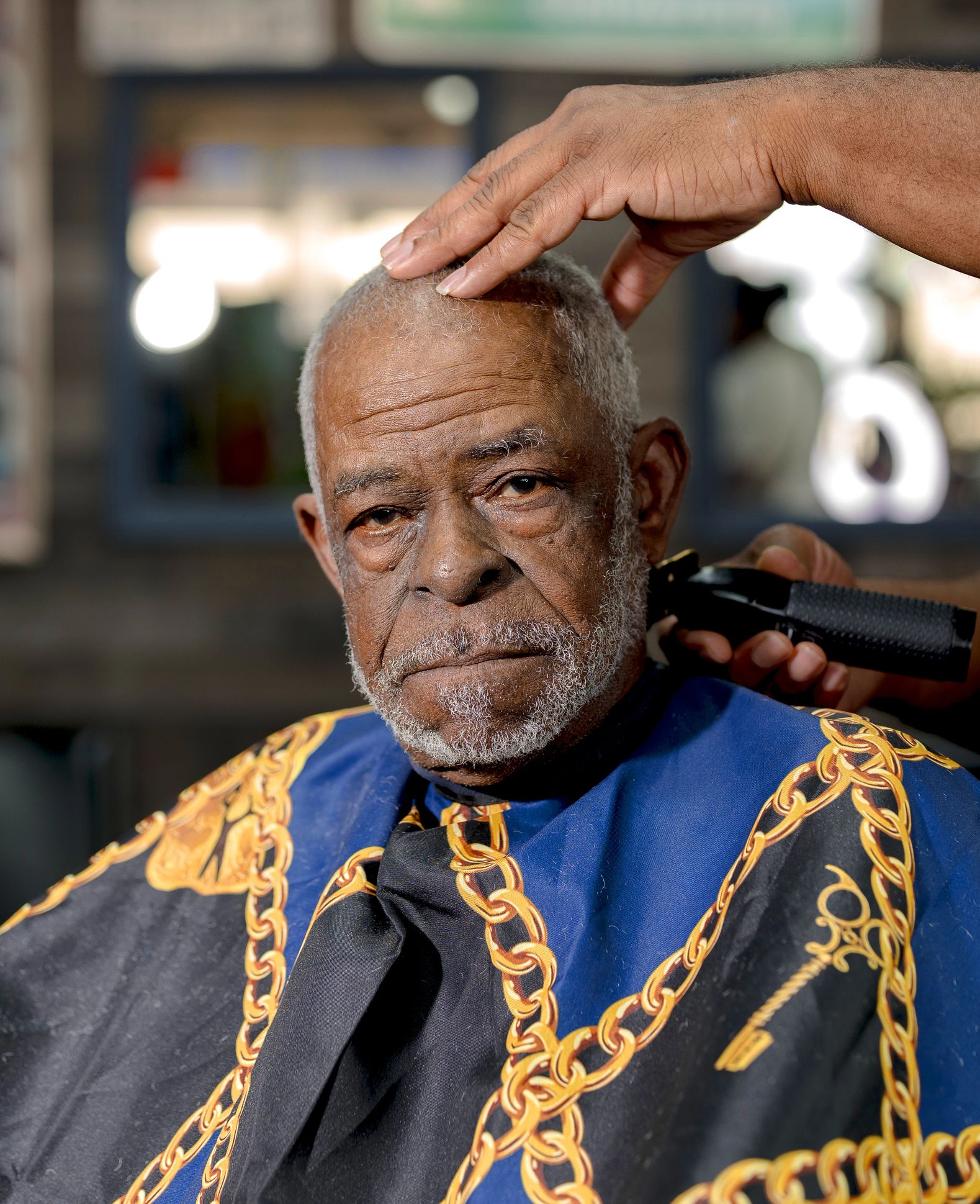 Jerry Spears Jr.  a man looks at the camera while he gets his hair cut