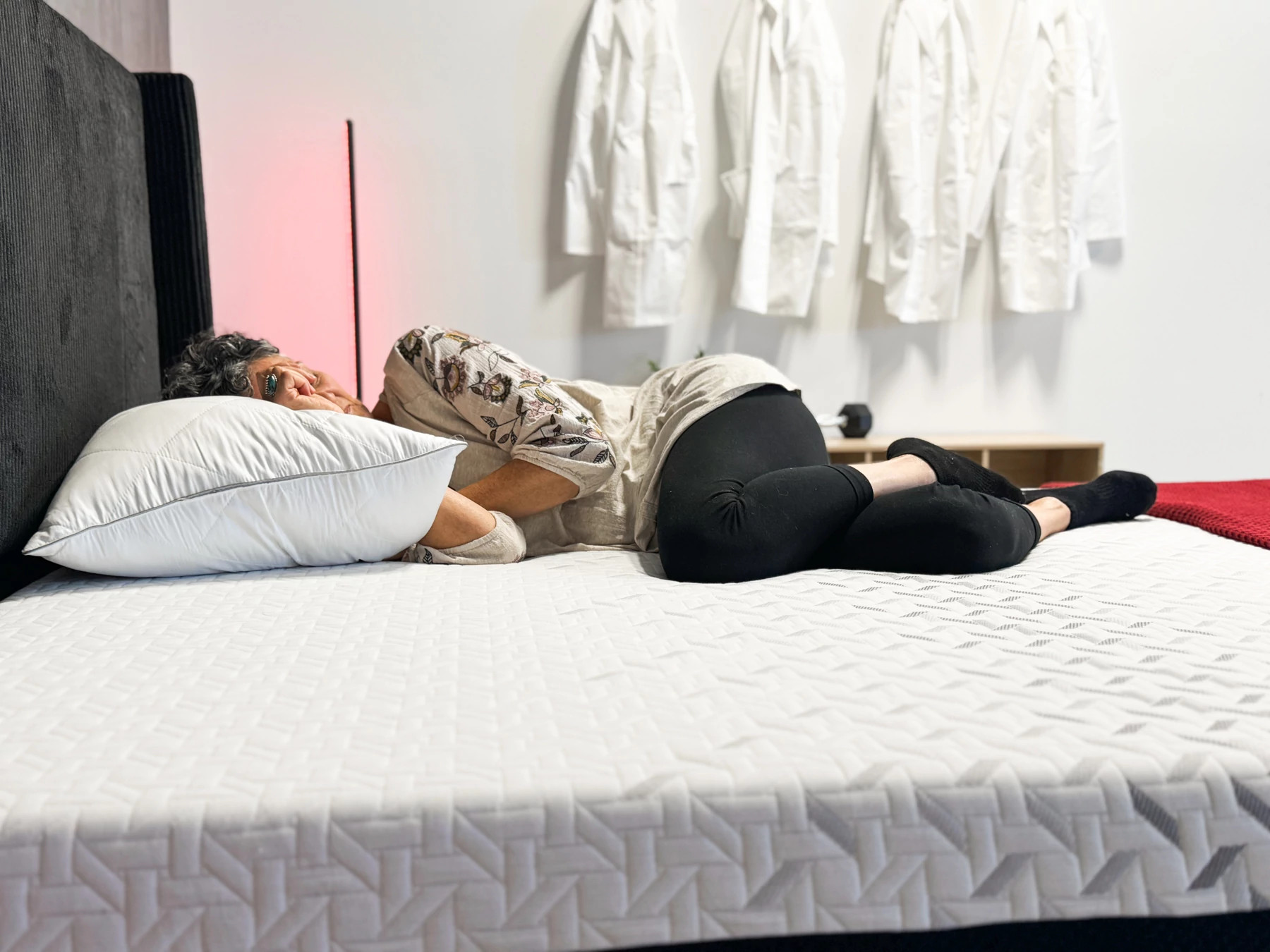 A woman lies on her side on the Nectar Premier Memory Foam mattress