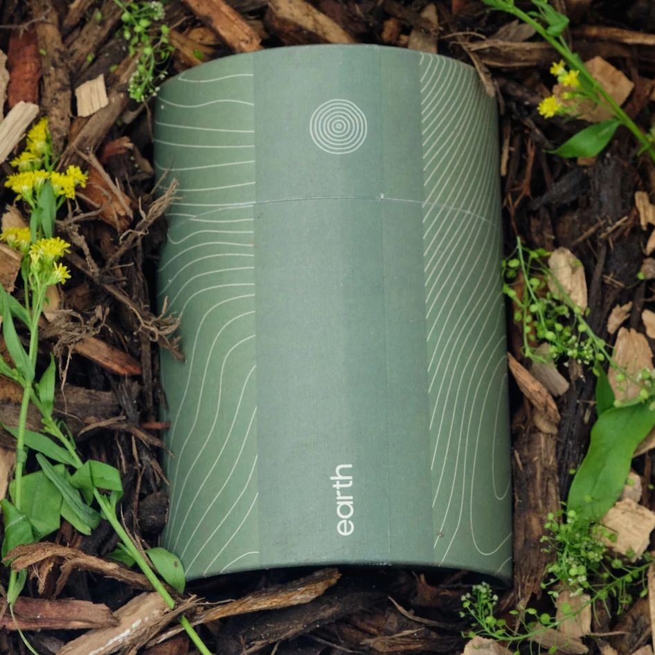 Earth Funeral a green canister with the word earth printed on it