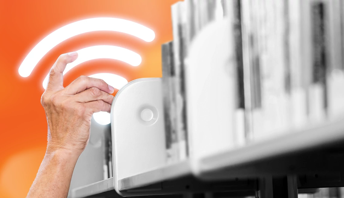 FCC Expands Libraries’ Wi-Fi Hot Spot Lending Program a hand next to wi fi bars