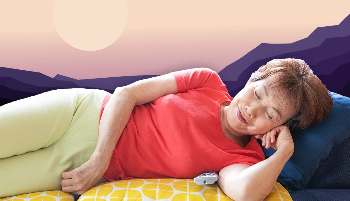 a woman laying on a couch napping