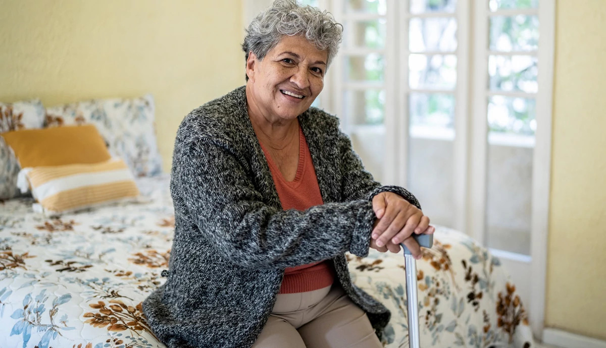 Woman sitting on bed and smiling