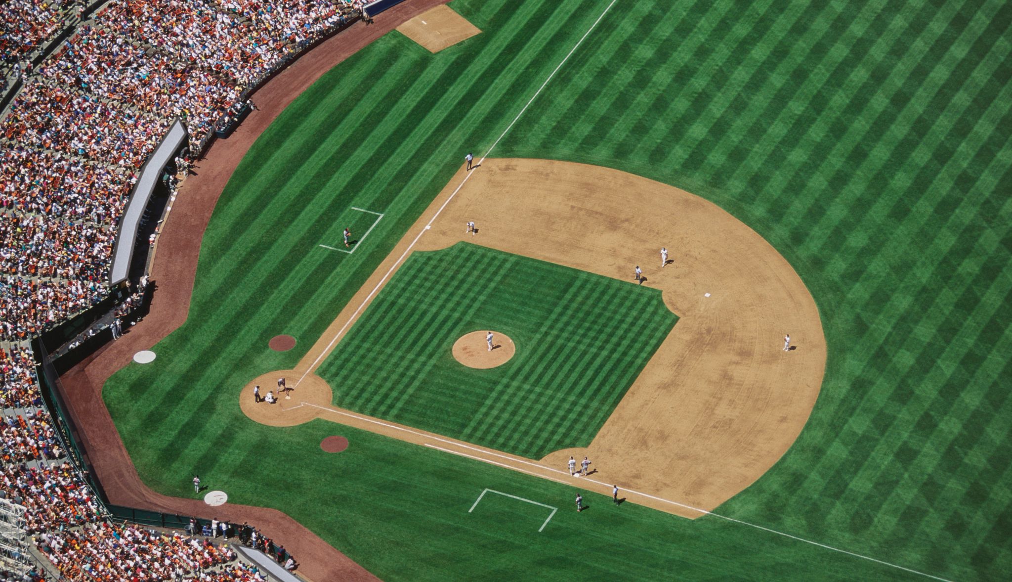 Baseball stadium filled with people during game. Baseball stadium filled with people during game.