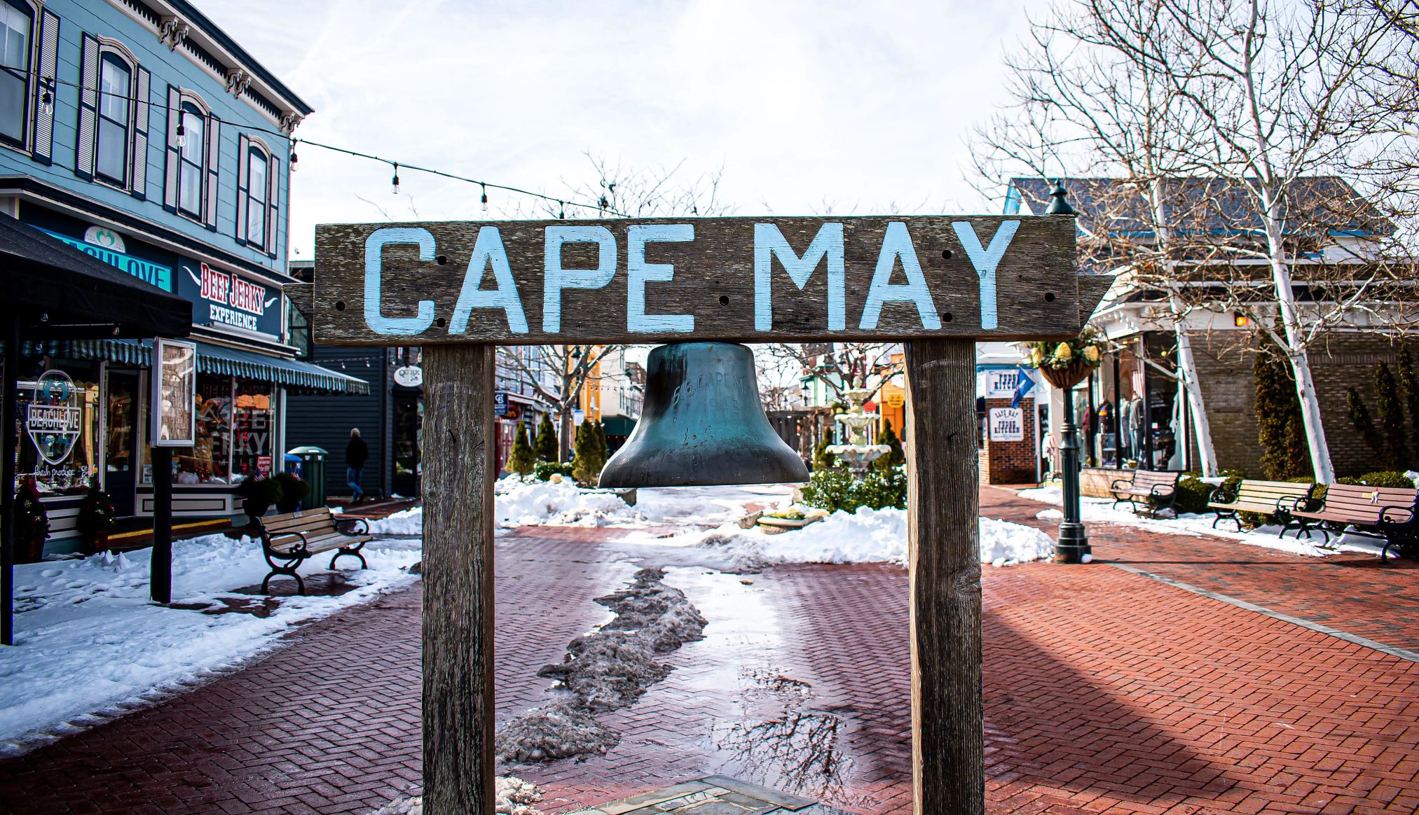 a sign that reads cape may in the center of a shopping area
