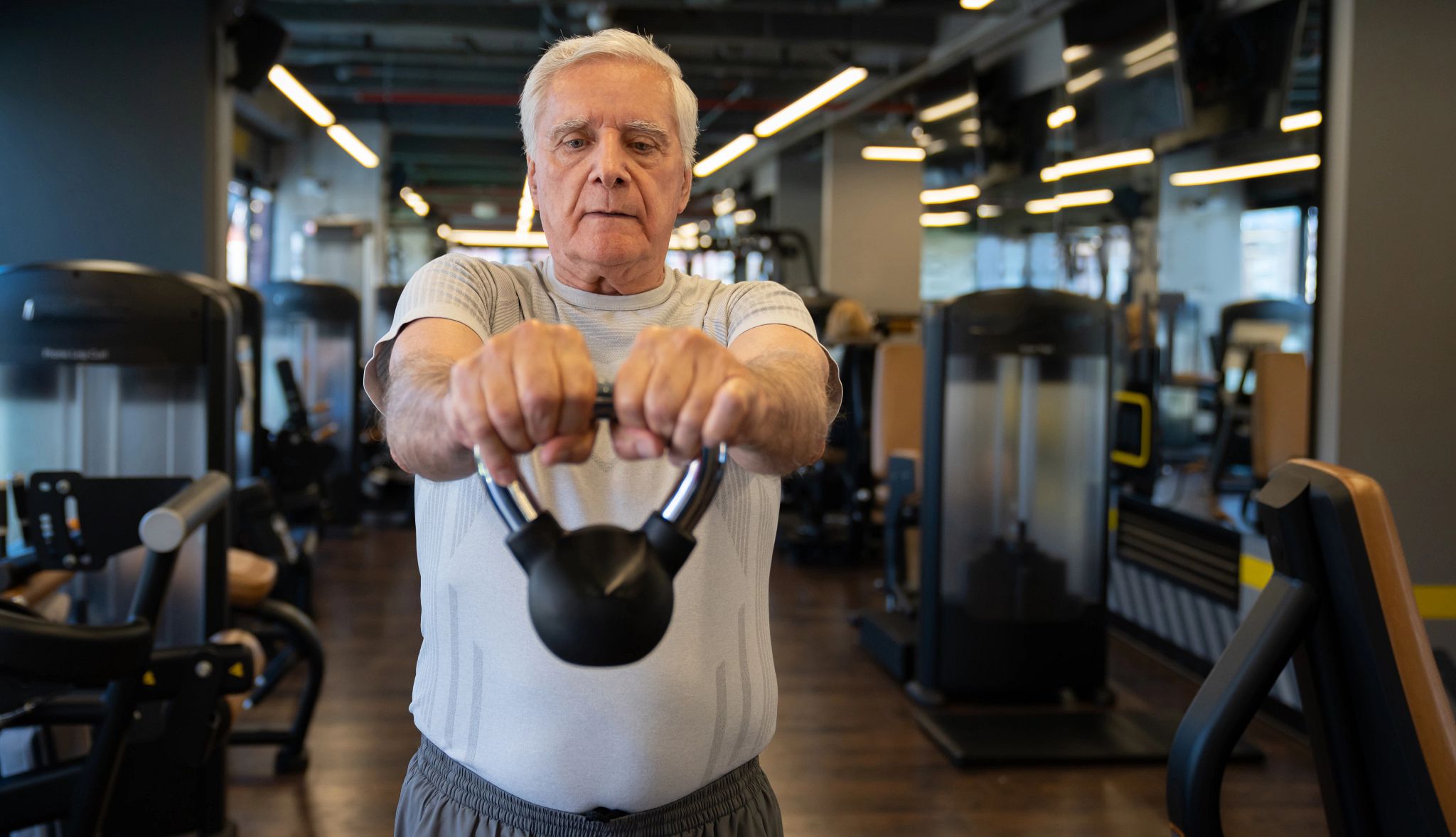 Portrait of a man exercising at the gym using a kettlebell Portrait of a man exercising at the gym using a kettlebell