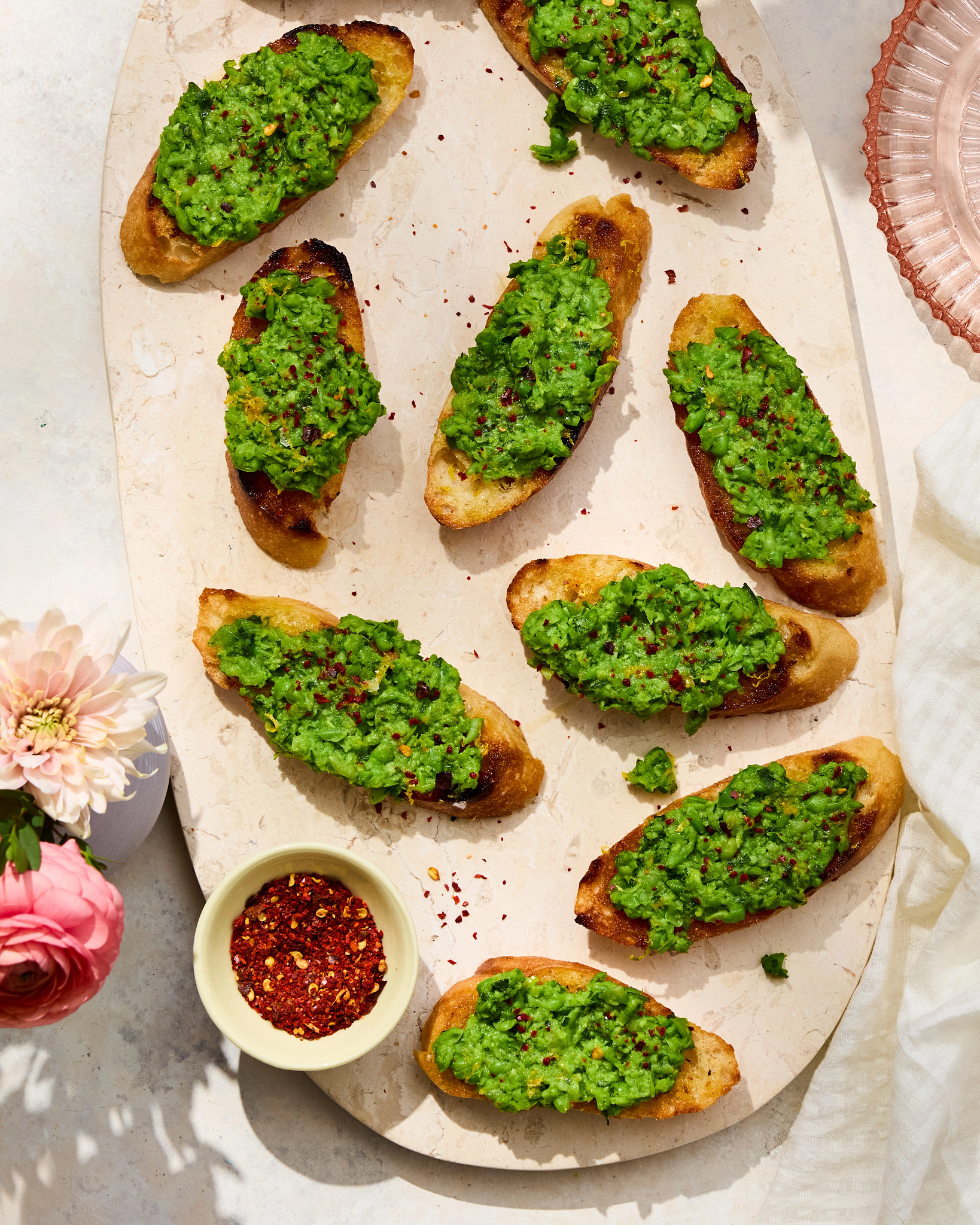 a photo shows Lemon Pea Mash Crostini