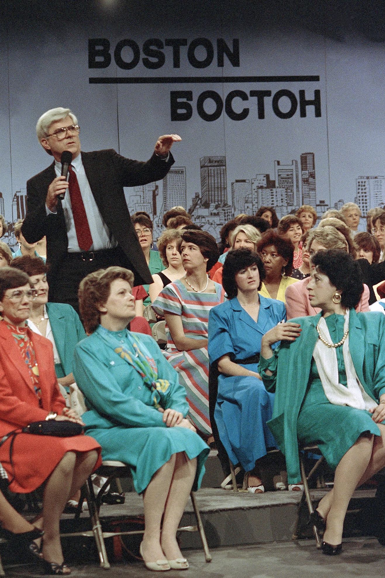 Phil Donahue Phil Donahue holding a microphone while standing in the audience as he hosts his talk show