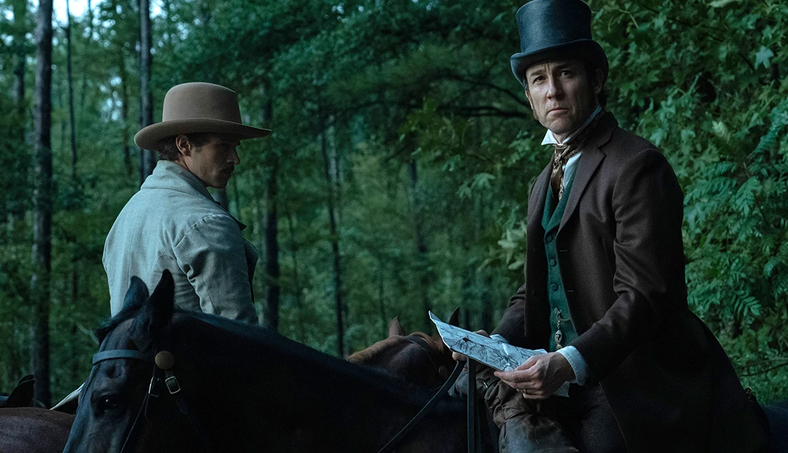 Brandon Flynn and Tobias Menzies riding on horses in the Apple TV+ series "Manhunt"