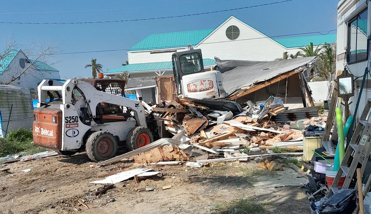 A bulldozer with a mess of building materials