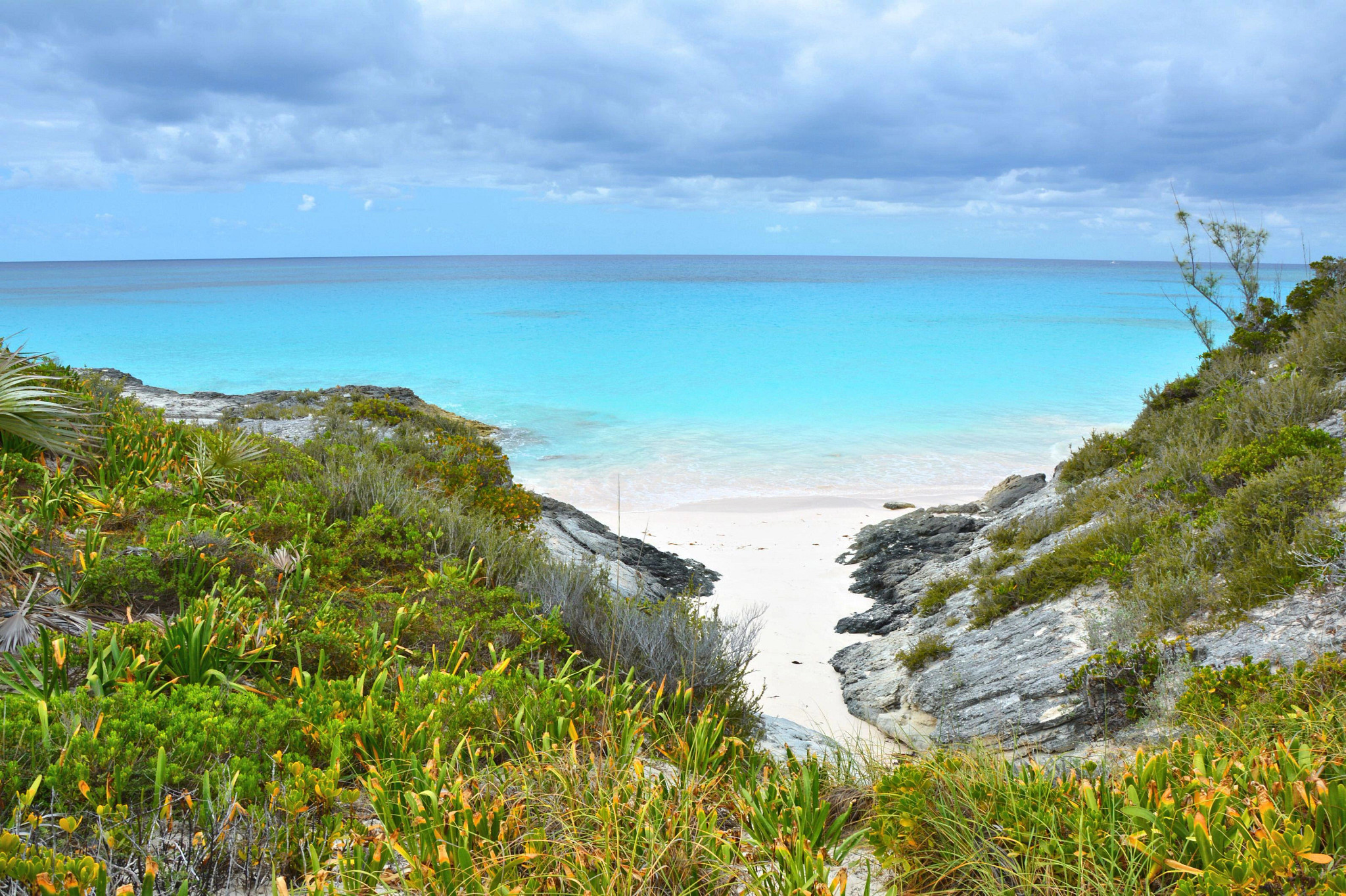 a rocky pathway leading to a beach