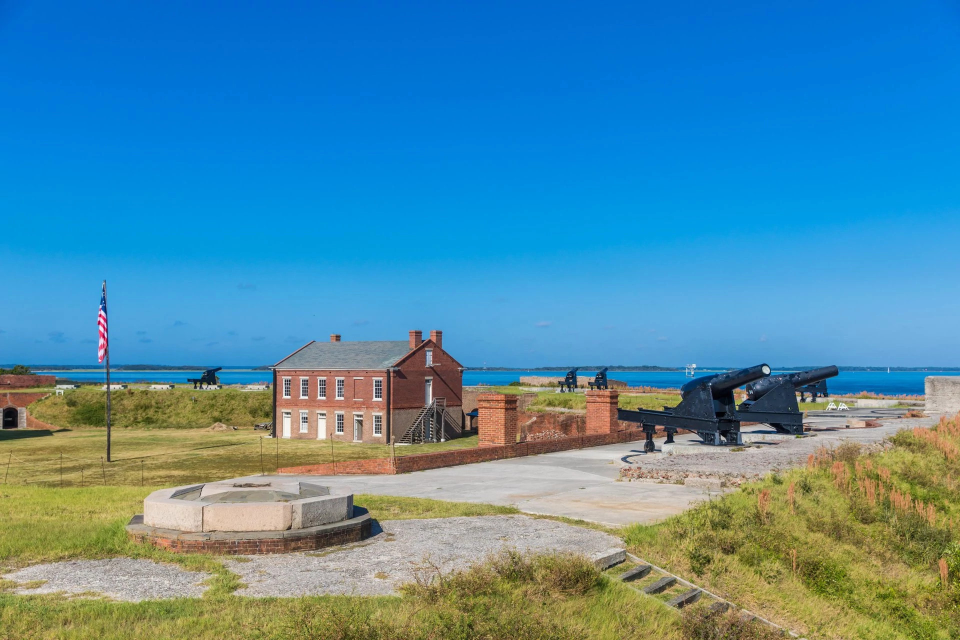 cannons near a building overlooking the ocean