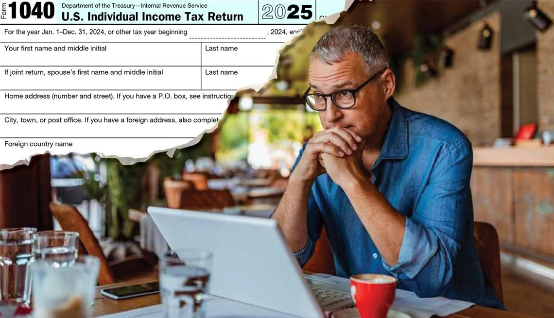 man stares at computer with tax return