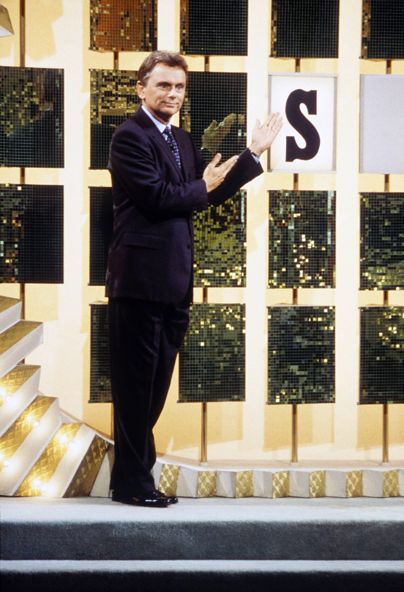 Pat Sajak turning over the letters on an episode of Wheel of Fortune