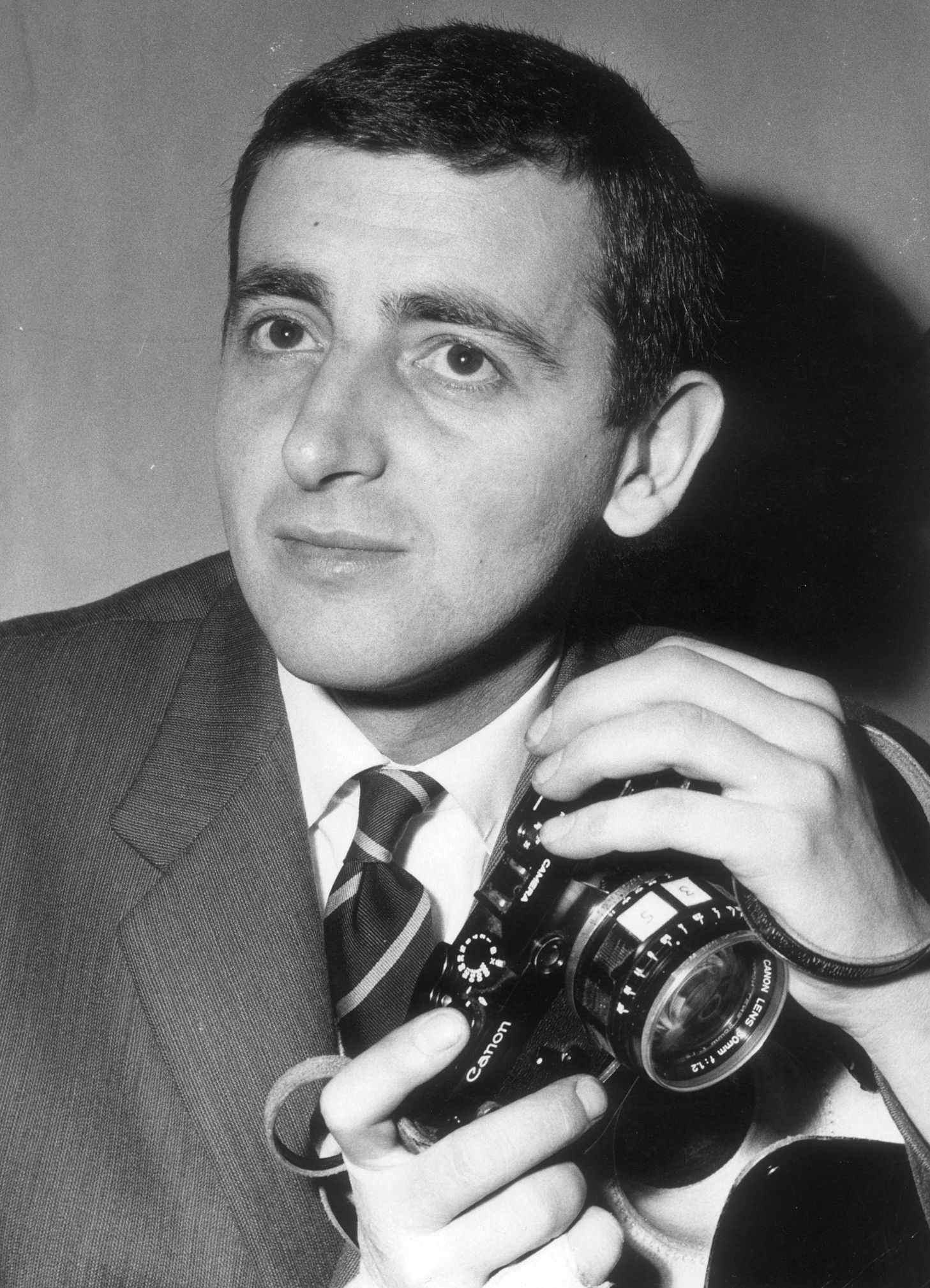 Harry Benson a young harry benson poses for a portrait while holding a canon camera