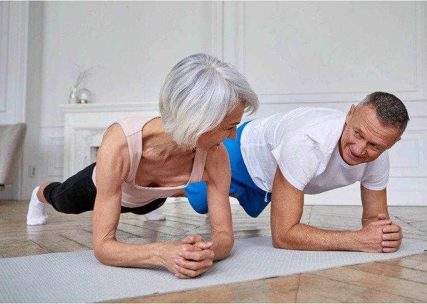 two people next to each other on a yoga mat in the planking position