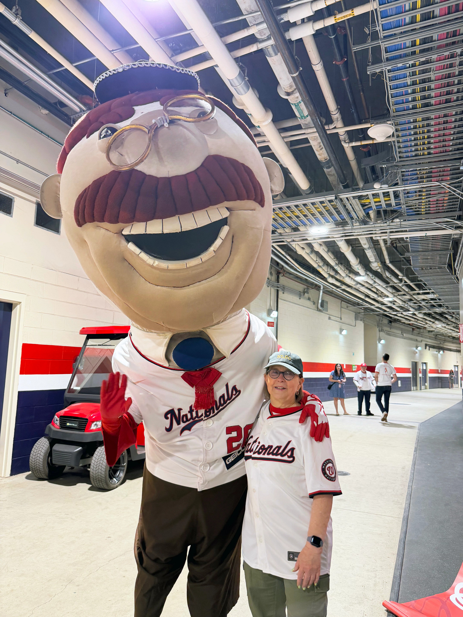 a photo shows Lori Evers, a Tax-Aide volunteer, after the president mascot race
