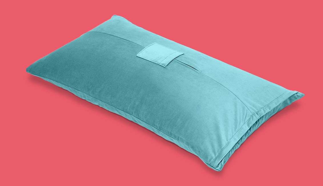 a teal mount pillow on a red background