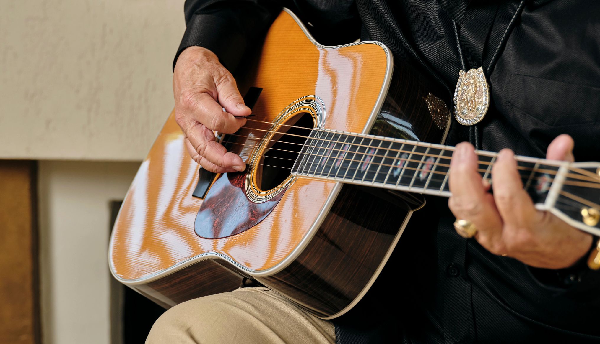 Don McLean plays “American Pie” a close up of hands playing an accoustic guitar.