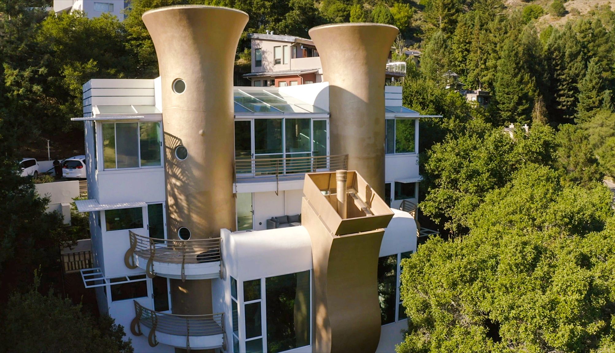 The 'Saxophone House' Big white house with two massive golden saxophone-shaped exterior columns and gold railings with large gold music notes on them