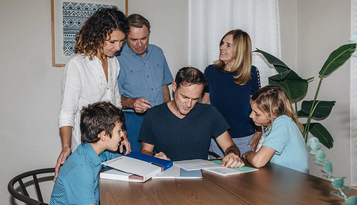 Family gathered around kitchen table reviewing estate planning documents