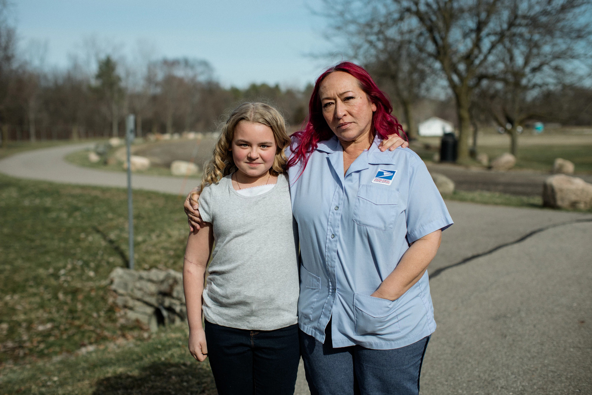 Rungphet Bodnar and Chloe Shanks pose arm-in-arm in a driveway 