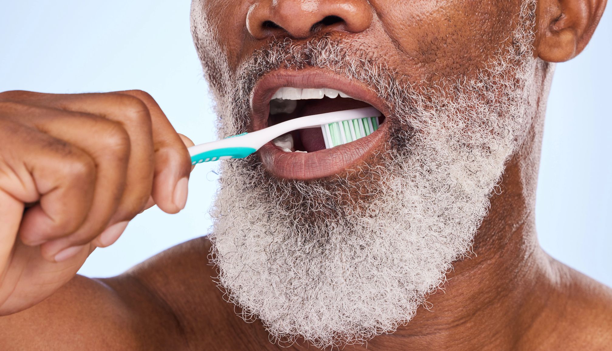 Habits to Live Longer man brushing his teeth