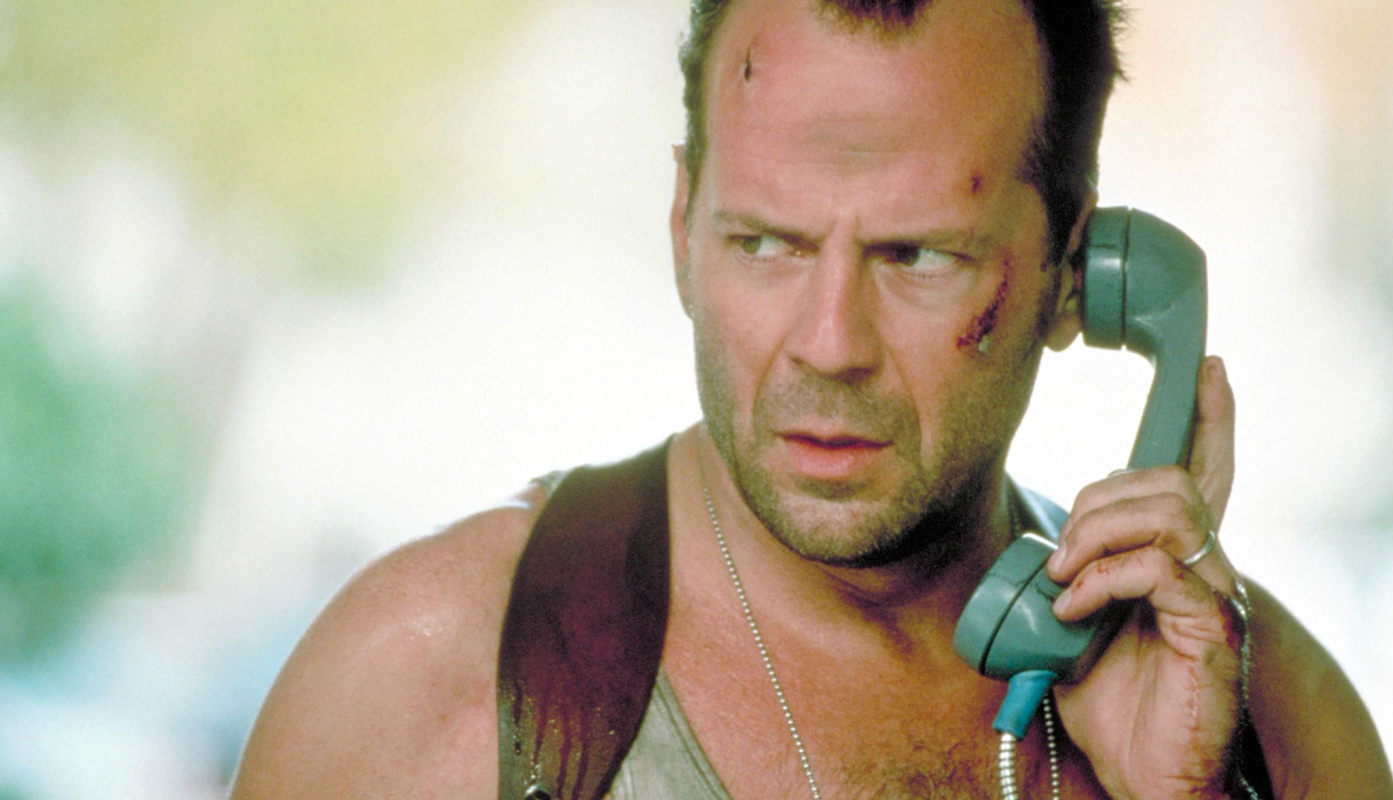 Bruce Willis talking on a phone in the film Die Hard with a Vengeance