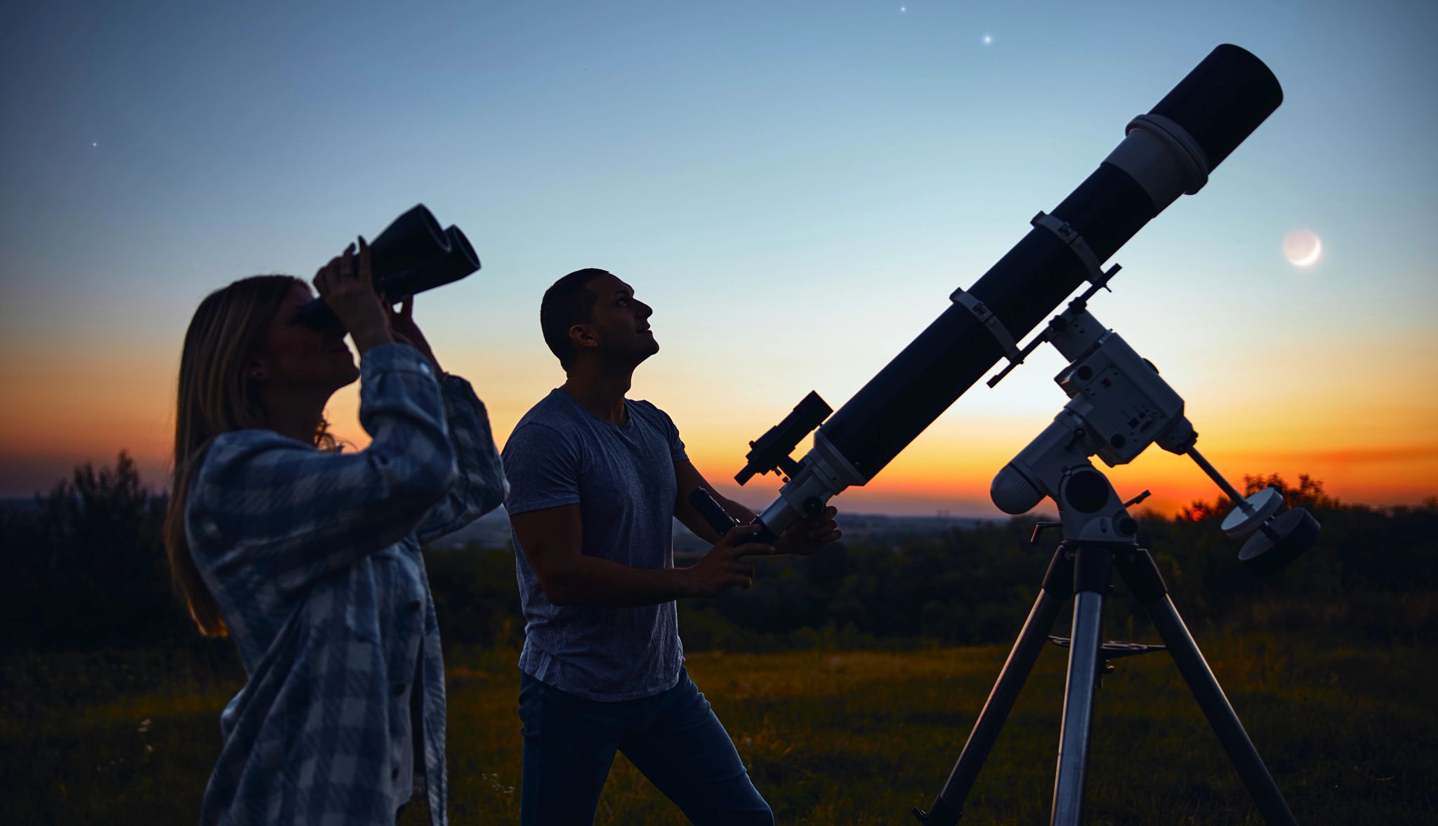 Image depicting the closer view of night sky A couple gazes upward, drawn to the celestial show, as the fiery sunset paints the sky