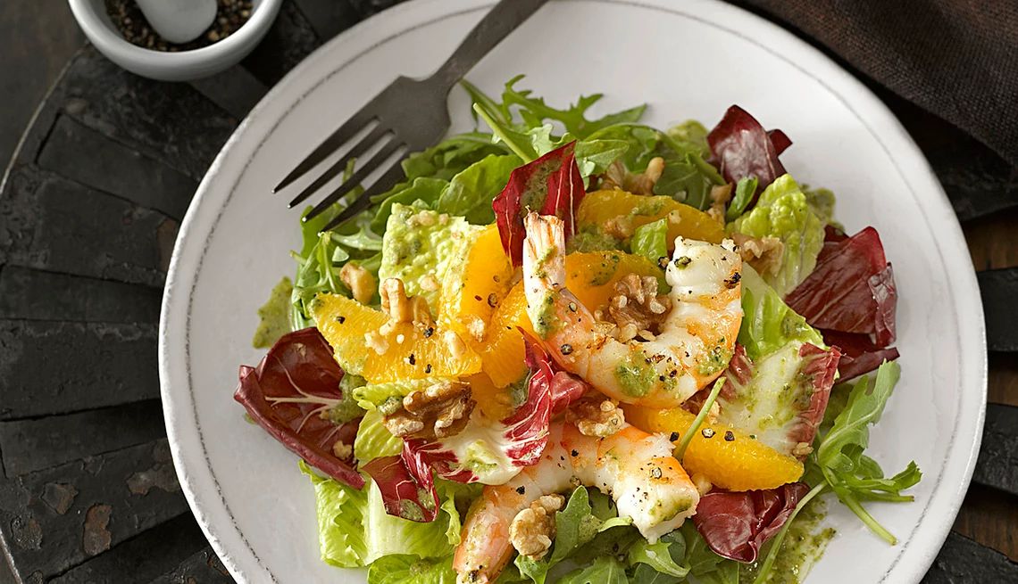 Orange and black pepper shrimp salad A close-up view of orange and black pepper shrimp salad on a plate