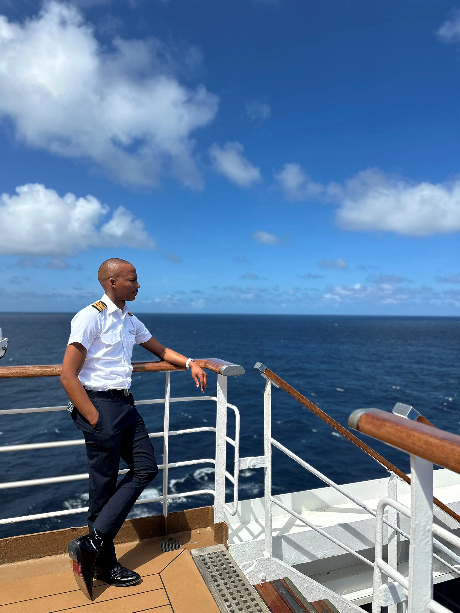 a man posing while on a cruise ship