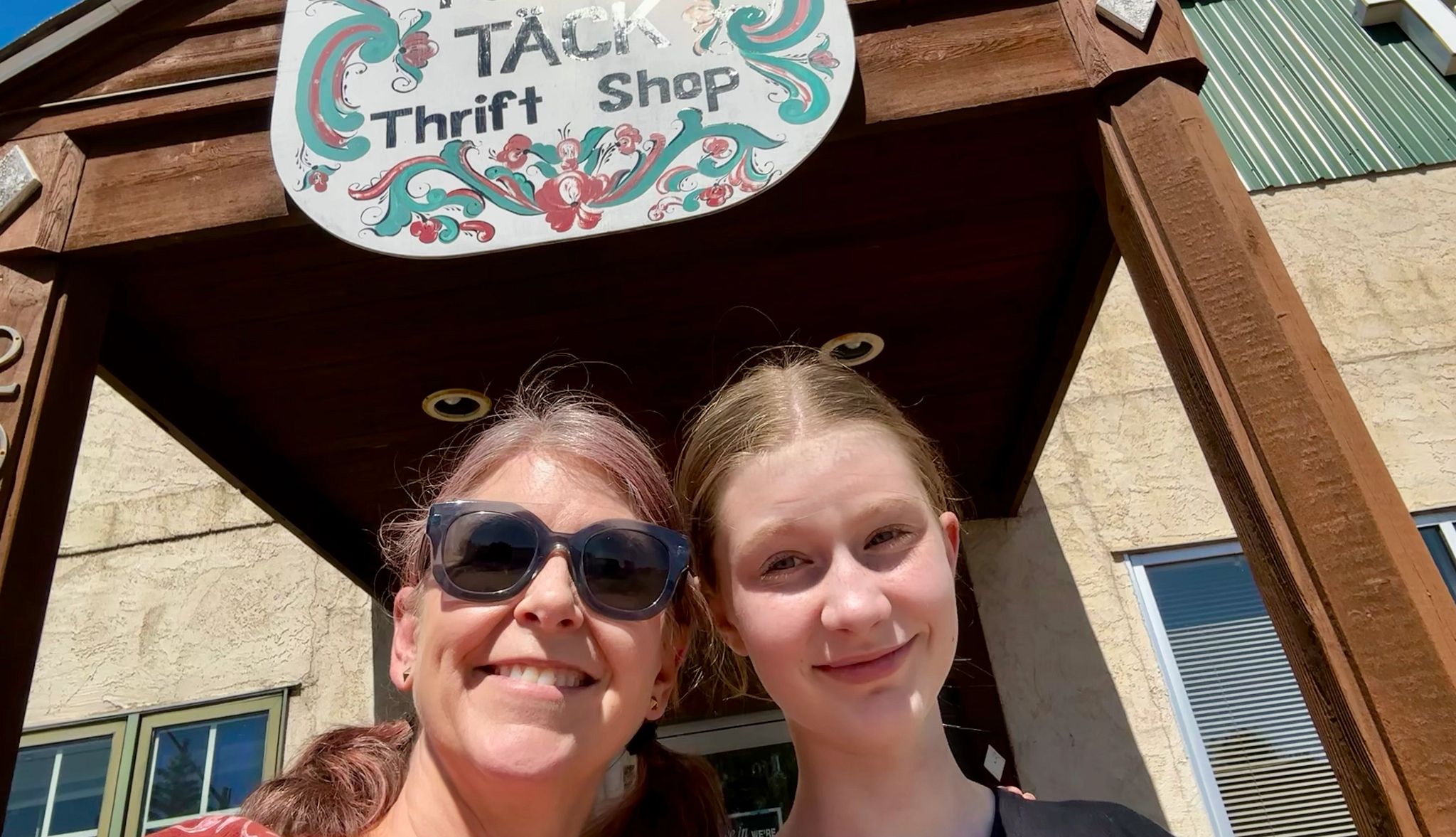 Thrift Road Trip a mom and daughter standing outside a storefront