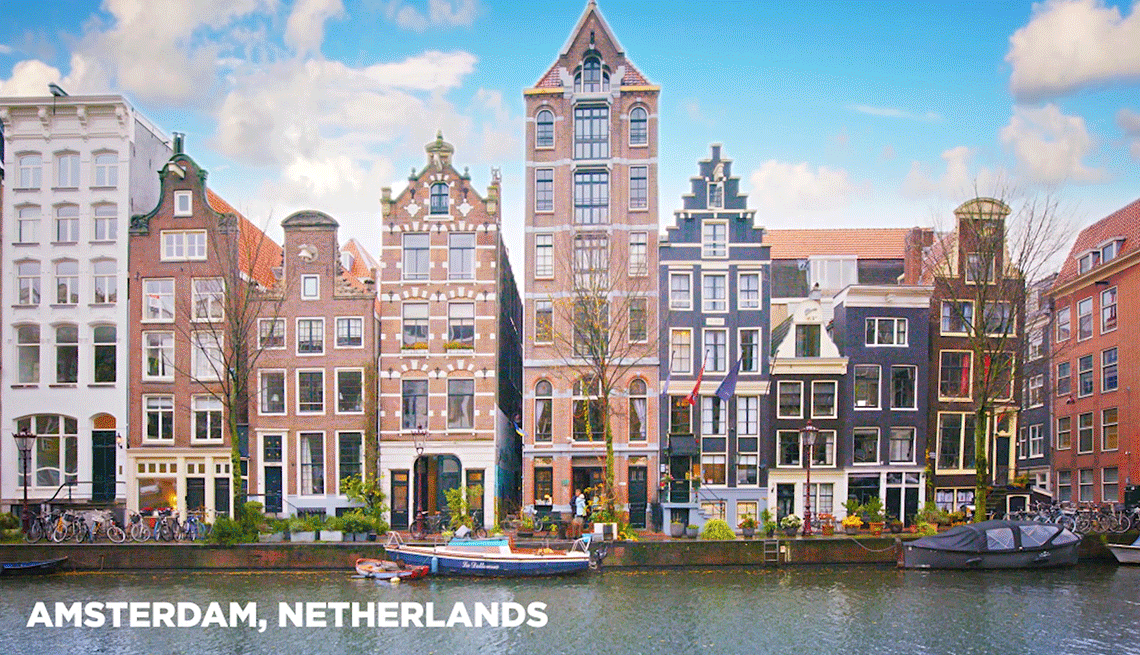 Amerterdam is a great destination for travelers 50-plus multi-color houses along a river in Amsterdam