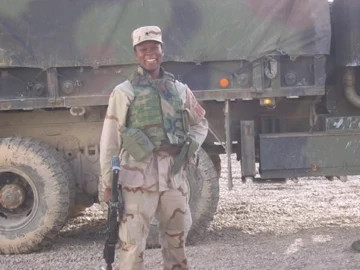 danielle green in uniform, standing in front of a military vehicle