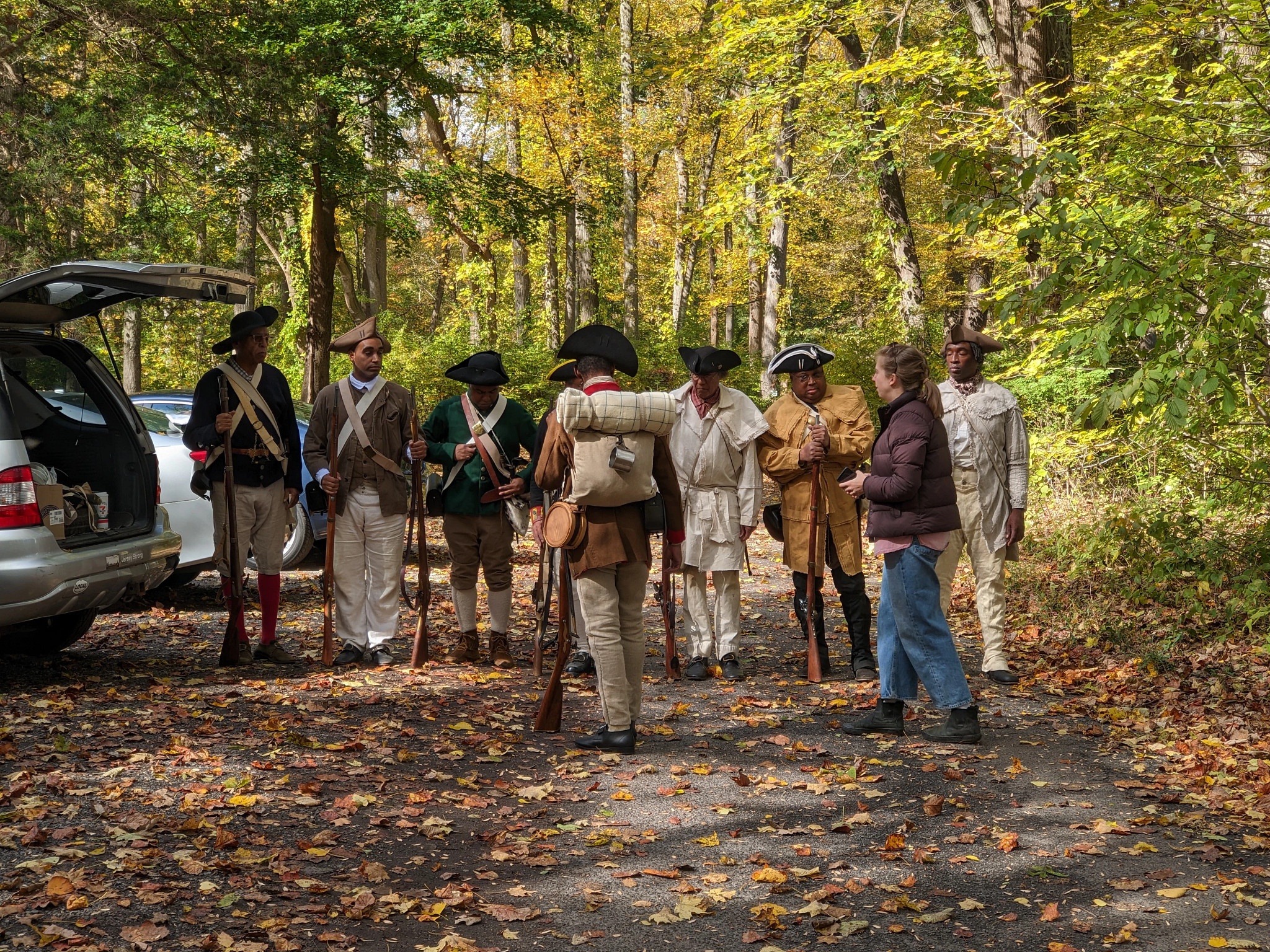 a producer speaking to reenactors dressed as soldiers in the american revolution