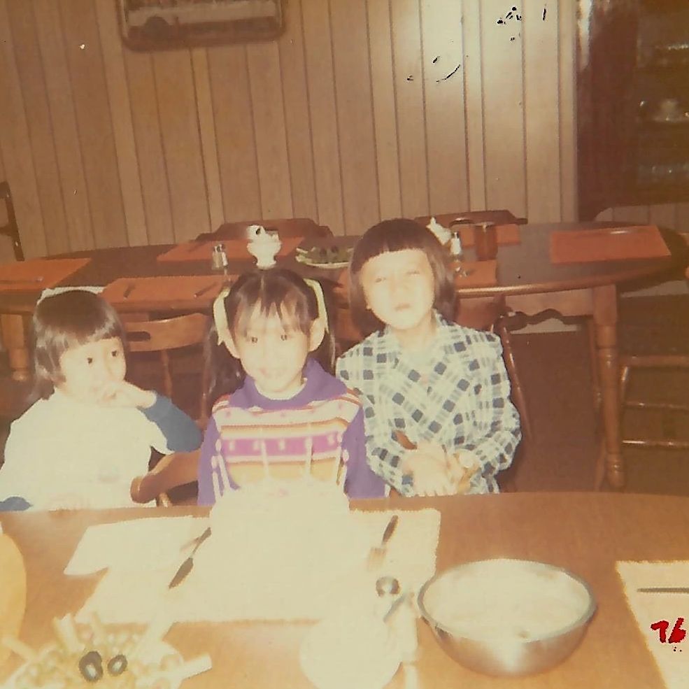 Vietnam refugees rebuild after fall of Saigon an old photo of three children sitting at a table with a birthday cake