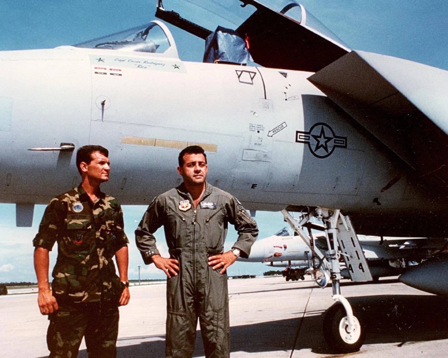 cesar rodriguez and david westrup standing together outside of a military aircraft