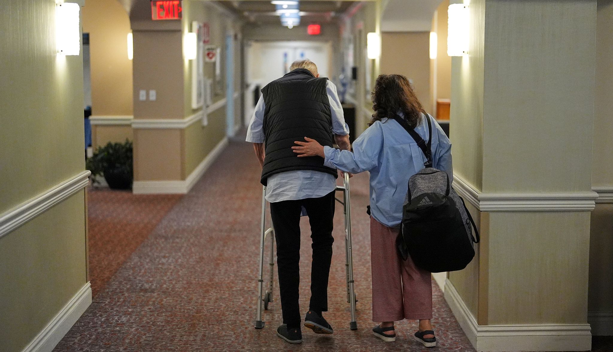 How the ‘One Big Beautiful Bill Act’ Could Impact America’s Nursing Home Residents people walking down a hall in a nursing home