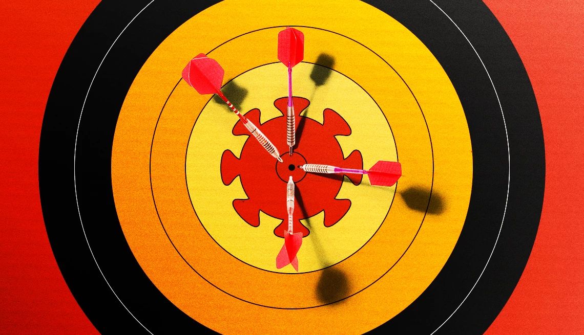 Darts on a Board With a COVID Spike a dart board with darts in a COVID spike