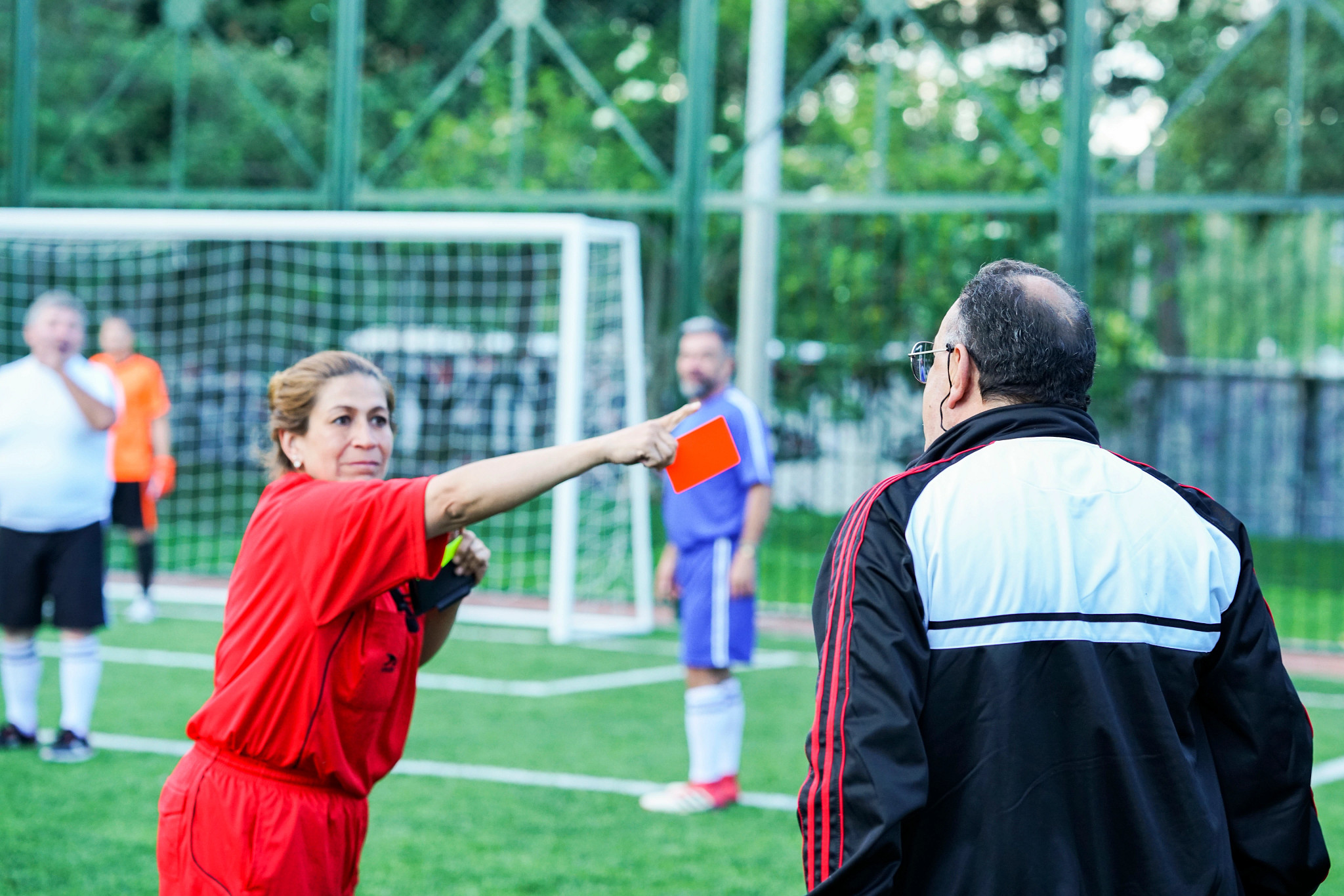 a referee issues a red card during a soccer match