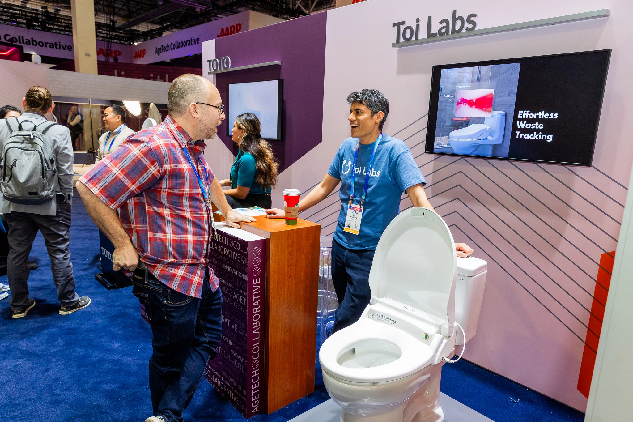 a person standing next to a smart toilet seat