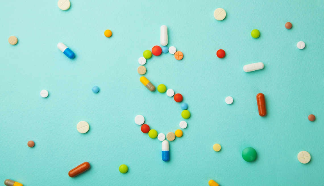 prescription pills in the shape of a dollar sign on a blue background